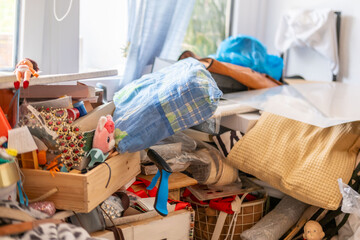 cluttered room with piles clothes and objects, chaotic interior, hoarding disorder concept, mess and overload, domestic space hoarding behavior and accumulation, lack organization mental overload © kittyfly