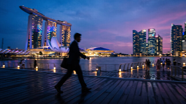 Businessman Running Along Waterfront at Dusk