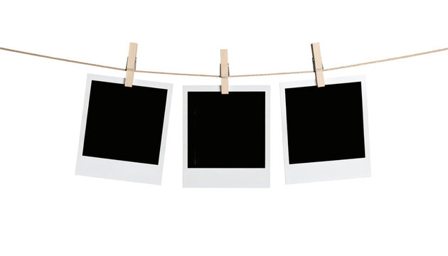 Blank photo frames hanging on a rustic wooden clothesline rope with wooden clips for displaying your memories, pictures, or creative designs&nbsp;