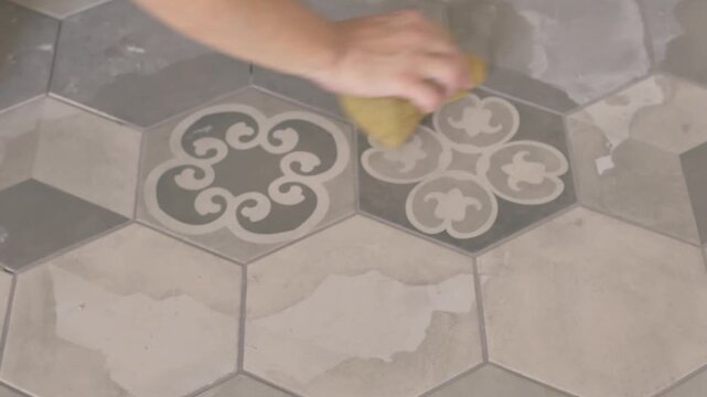 Hand Shaping Tile Grout with Sponge on Ceramic Floor Tiles