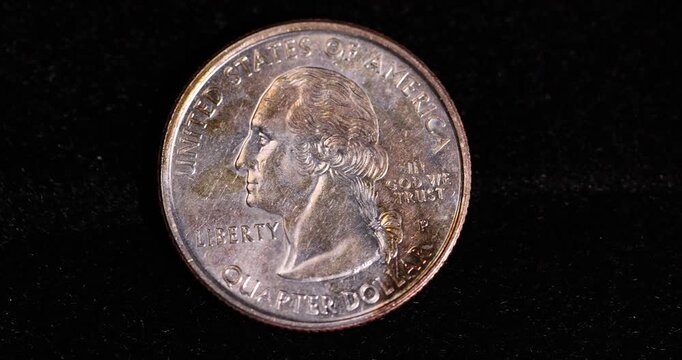   quarter-dollar coin on a black velvet cloth, one damaged 25-cent coin covered with yellow rust and plaque, close up