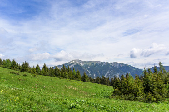 A breathtaking landscape of Rax, Austria showcasing vivid green hills under a clear blue sky