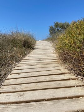 Wooden boardwalk leading to the beautiful beach in Agios Arsenios, Naxos island, Greece
