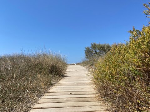 Wooden boardwalk leading to the beautiful beach in Agios Arsenios, Naxos island, Greece