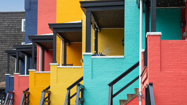 Colorful residential row houses with brick walls and porches