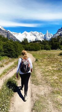 A female tourist is walking along the Laguna Torre hiking trail near El Chalten, Argentina