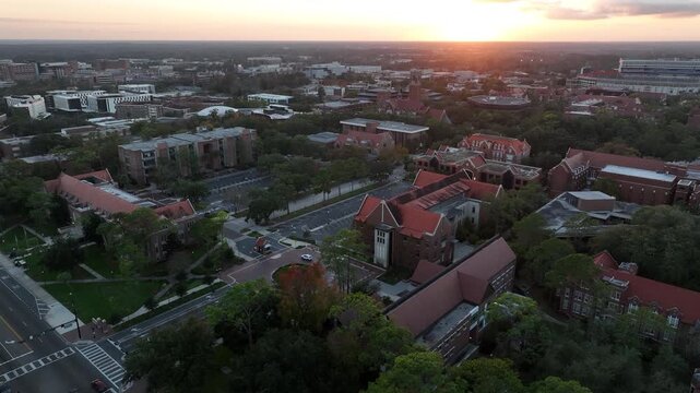 The setting sun illuminates the buildings of historic downtown Gainesville, Florida, USA.