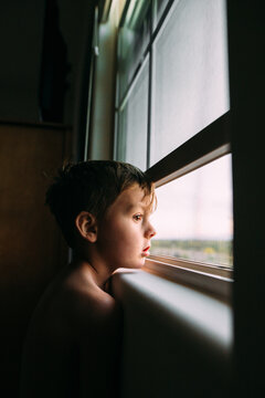 profile of a boy looking out window