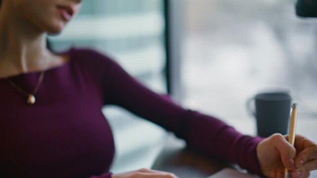 Close up business woman sketching idea in notebook by window creative workplace