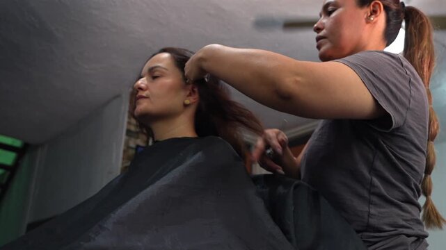 Professional hairdresser styling a woman's hair in a beauty salon