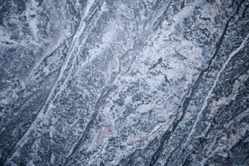 Naklejka premium Blue-grey granite surface with diagonal crystalline mineral veins background texture