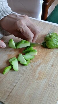 Cutting Chayote on a Wooden Cutting Board for Cooking