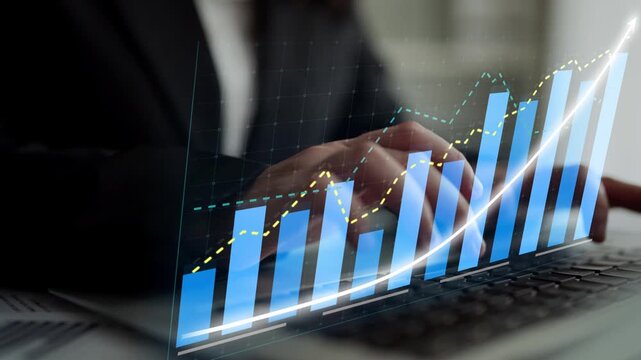 A business executive analyzes growth data using a laptop, with a digital graph overlay representing progress and trends, captured in a modern office space. Copula