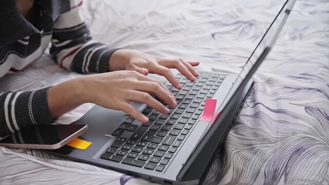 Woman typing on a laptop keyboard key, conveying typing, digital communication and focused office work.