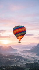 Fototapeta premium Colorful Hot Air Balloon Floating Over Misty Valley at Sunrise