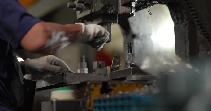 Metal stamping press machine punching and forming small metal parts one by one in factory