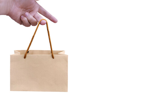 A small paper shopping bag in hand PNG transparent.