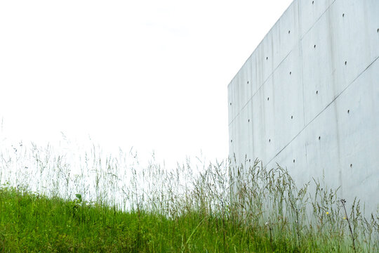 green grass and cement building on the white sky background