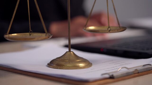 Corporate Lawyer Conducting Legal Research with Justice Scales in Modern Office