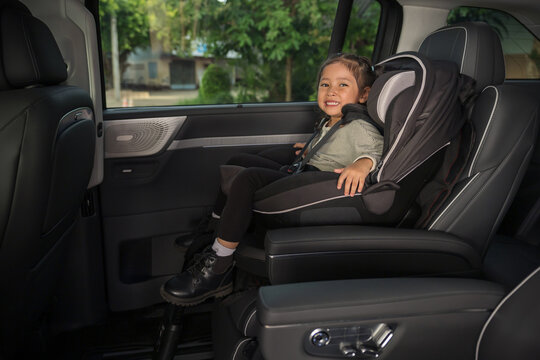 happy preschool child girl sitting in car seat, safety baby chair travelling