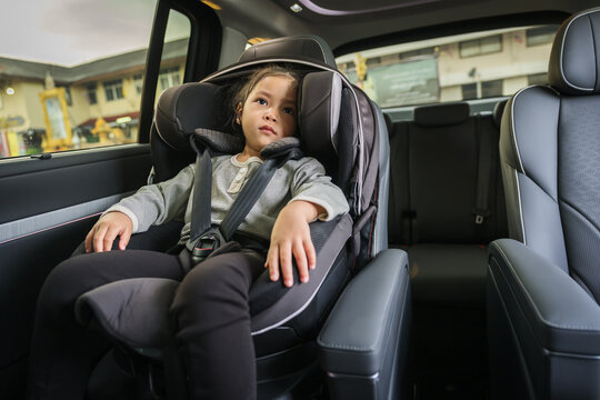 preschool child girl sitting in car seat, safety baby chair travelling