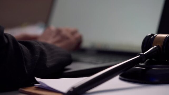 Judge&rsquo;s Gavel and Lawyer Preparing Legal Case on Laptop in Modern Law Office