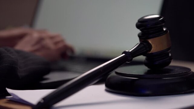 Judge&rsquo;s Gavel and Lawyer Preparing Legal Case Files at Modern Law Office