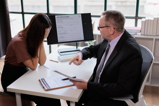 Employee covering face. Feeling overwhelmed by stress and emotional distress during an intense office meeting with an employer pointing. Symbolizing workplace bullying. Conflict