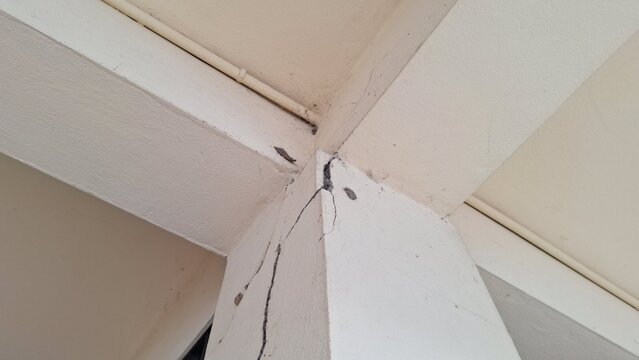 Structural crack on concrete pillar and ceiling beam corner