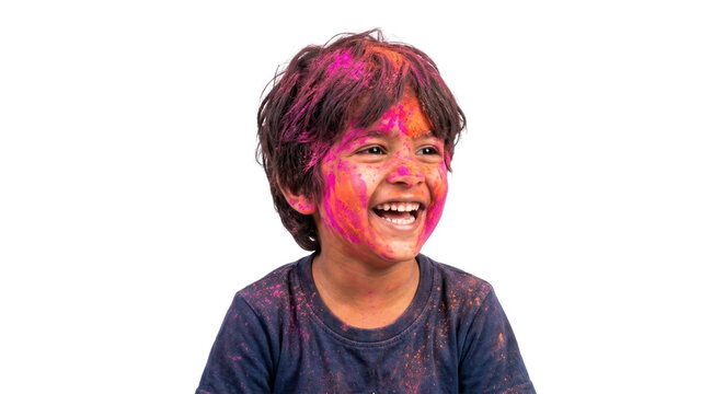 Smiling young boy covered in vibrant pink and yellow holi powder on his face and shirt
