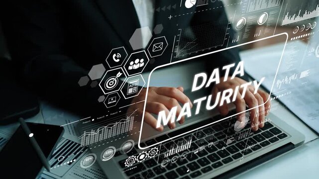 Business Professional Analyzing Data Maturity Metrics with Digital Graphs on Laptop in Modern Office Environment. Asymptotic smart data analytic.