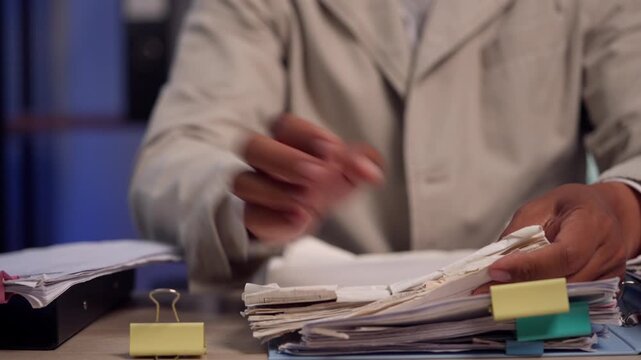 Attorney Organizing Legal Case Files and Office Documents for Client Consultation