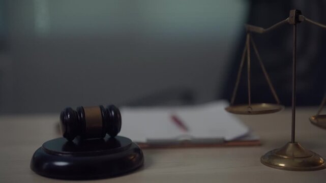 Judge Gavel and Scales of Justice with Legal Documents on Office Desk