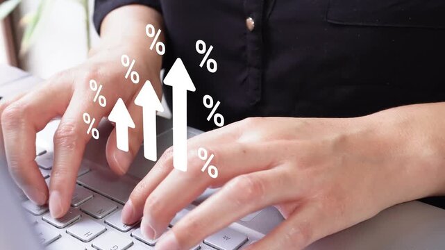 Close-up view of an executive typing on her laptop with an animated graphic of rising arrows surrounded by percentage symbols. Ideal for tables, reports, or financial visual representations.