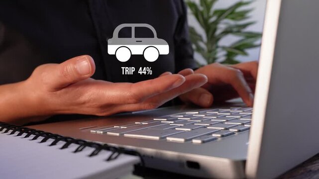 Close-up of a businesswoman's hands working on her laptop while holding a fill animation with a car percentage counter and the word "Trip".