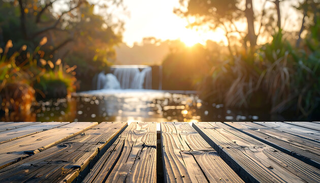 Wooden deck near serene waterfall landscape.