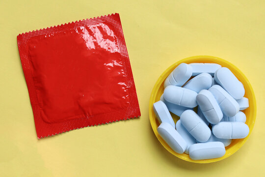 Close-up of HIV prevention concept featuring PrEP medication and a condom