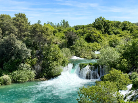 Lovely turquoise color waterfalls and cascade mountain river in the forest during late spring