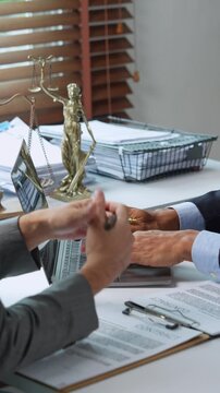 Lawyers discussing contract terms in office