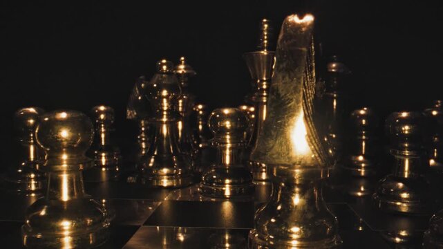 A single golden chess piece illuminated by warm dramatic lighting on a dark board with other pieces visible in the background.