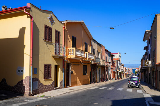 Traditional narrow street with colorful houses in the town of Sant'Antioco, Sardinia, Italy