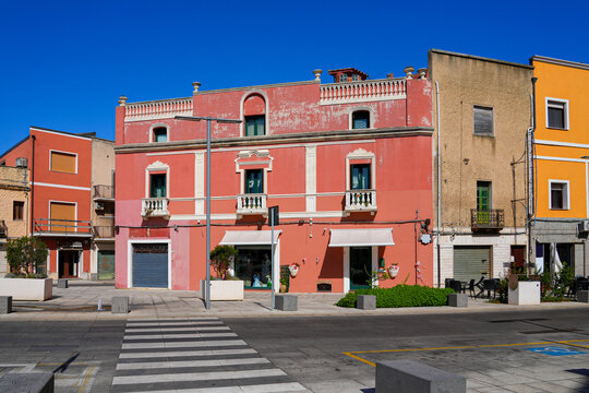 Historical pink building on Piazza Umberto I in the sunny town of Sant'Antioco, Sardinia, Italy