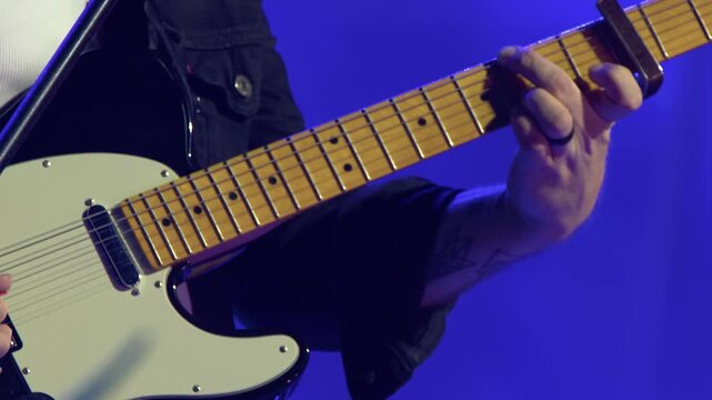 Male guitarist plays Fender Telecaster electric guitar at live gig