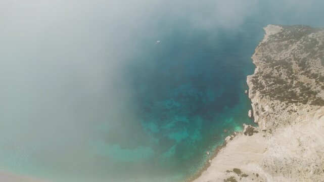 Fog over turquoise bay and rocky coastline in Kefalonia Ionian Island Greece