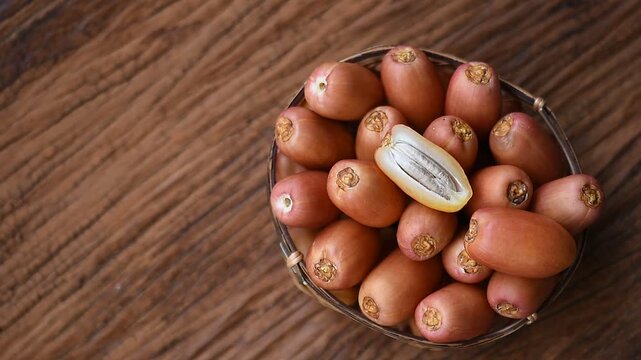 Date palm or Phoenix dactylifera fruits on an old wooden background.top view.