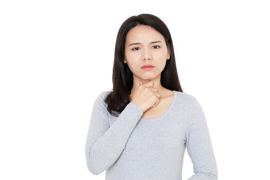 A young Chinese woman with a sore throat in the bedroom