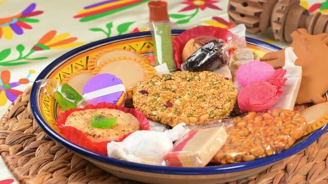 Assortment of artisan Mexican confectionery with a wooden molinillo on th background