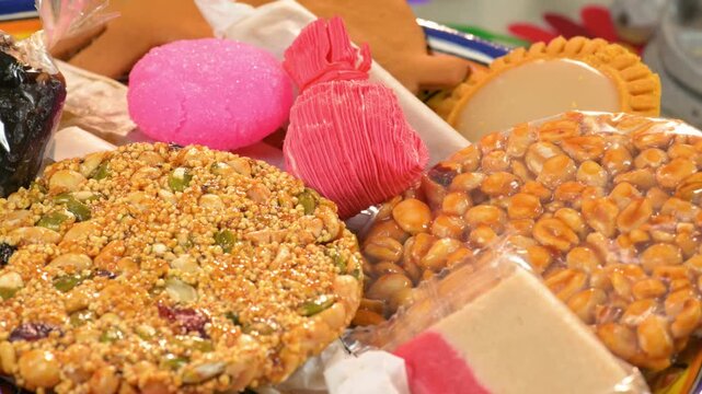 Close-up of Mexican amaranth candy "alegria" with pink coconut candy and peanuts