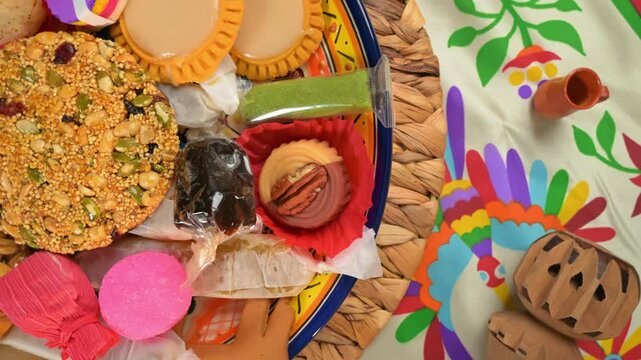 Top view of traditional Mexican treats and colorful candies on a talavera plate