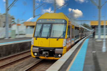 Fototapeta premium Passenger Train going through Lewisham Train Station at Sunset a suburban Sydney train Station in Sydney NSW Australia
